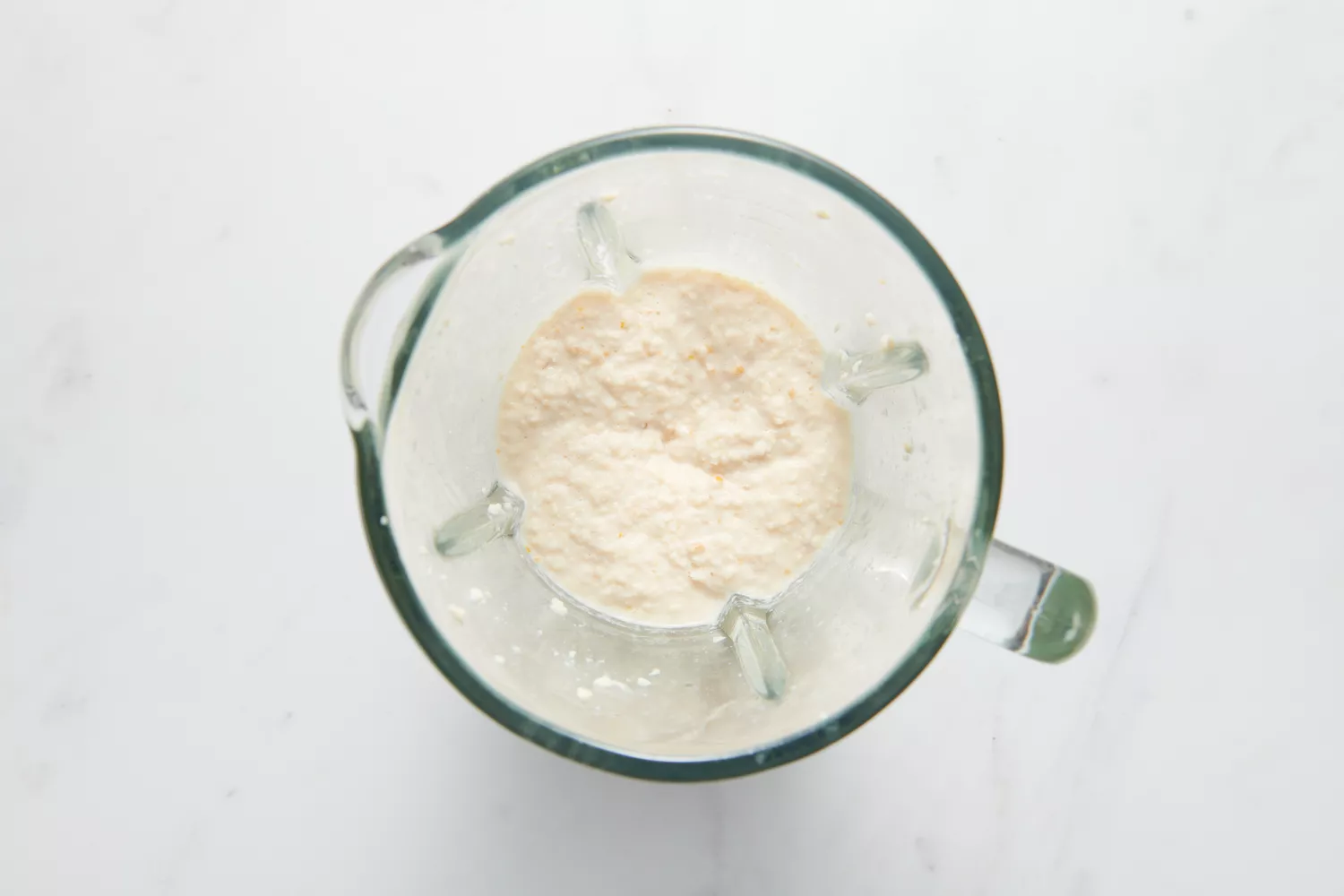 Um liquidificador com a massa de urad dal e feno-grego batida