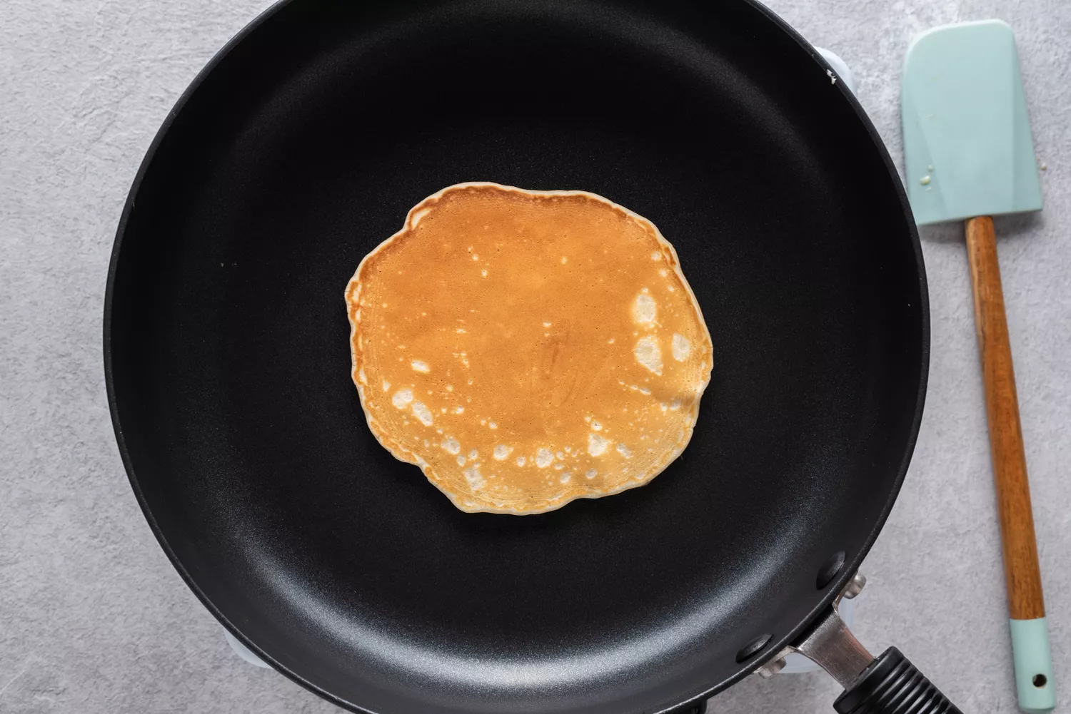 Pancake in a skillet, flipped